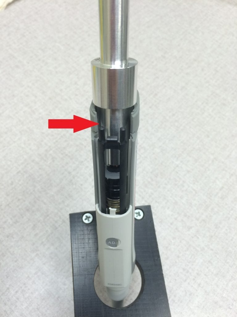 Calibration adjustment tool inserted into pipette